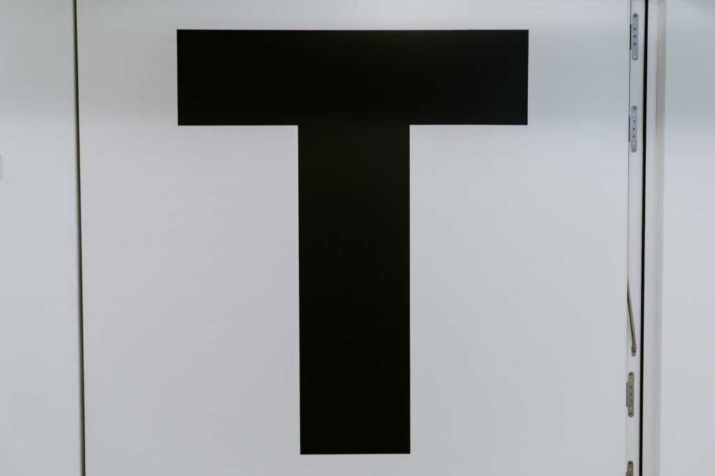 Black letter T on a white door