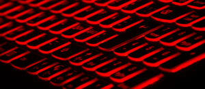 Black keyboard buttons lit up with red light