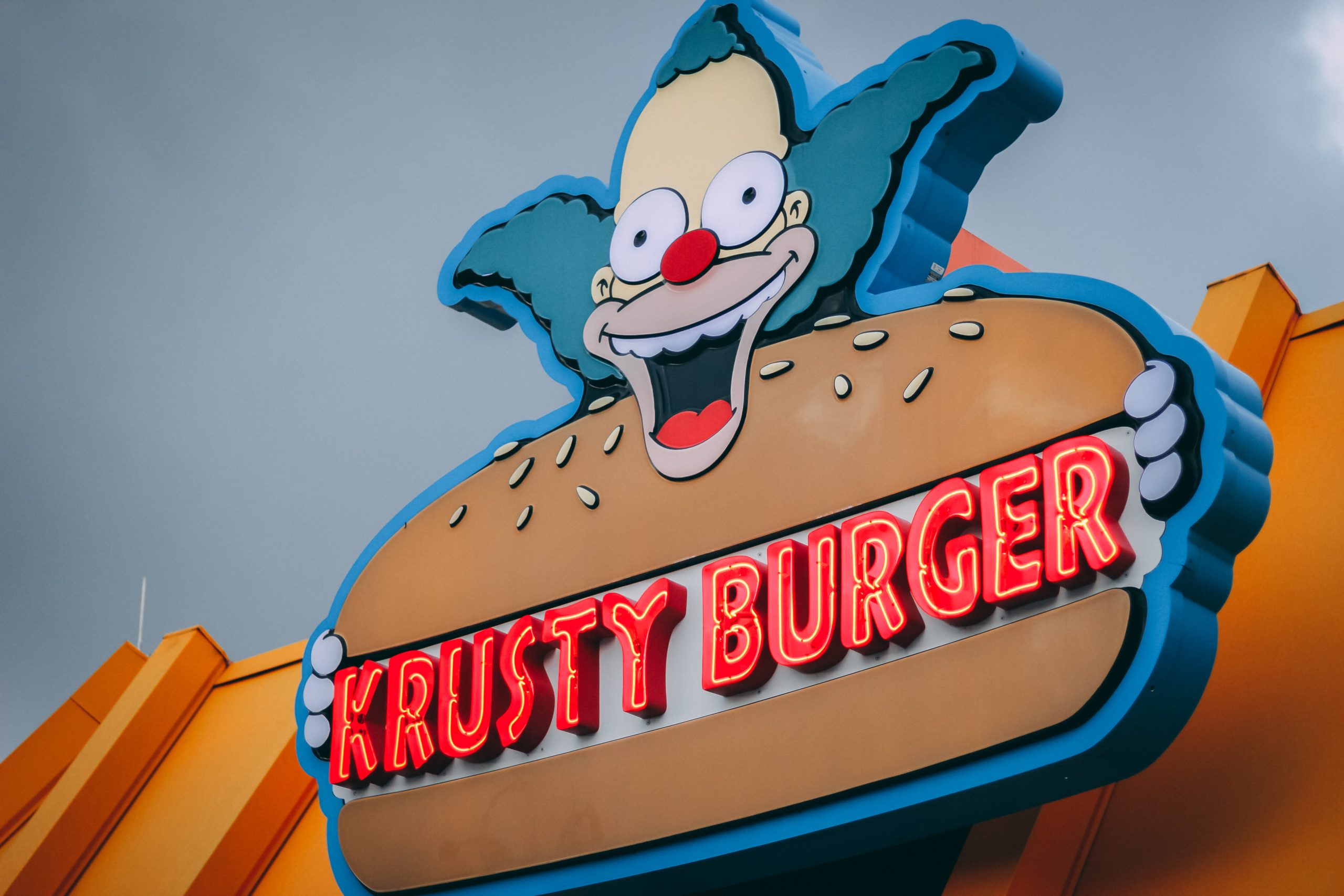 Krusty Burger logo of Krusty the Clown with neon lights